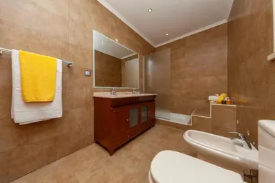 a bathroom with a sink and a toilet and a mirror at Villa Florida by Algarve Vacation in Albufeira