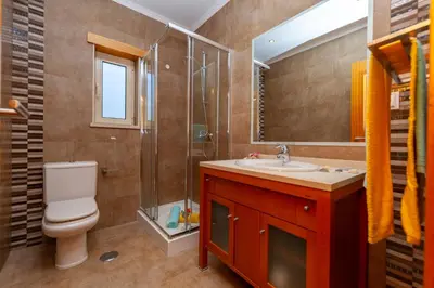 a bathroom with a toilet and a sink and a shower at Villa Florida by Algarve Vacation in Albufeira