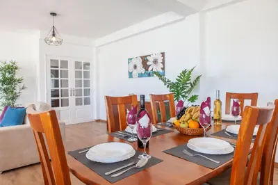 a dining room with a wooden table with a bowl of fruit at Villa Abel by Algarve Vacation in Albufeira