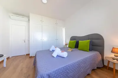 a bedroom with a bed with two stuffed animals on it at Villa Abel by Algarve Vacation in Albufeira