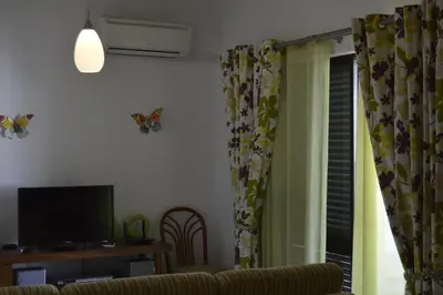a living room with a couch and a window with butterflies at Casa de Vilamoura in Vilamoura