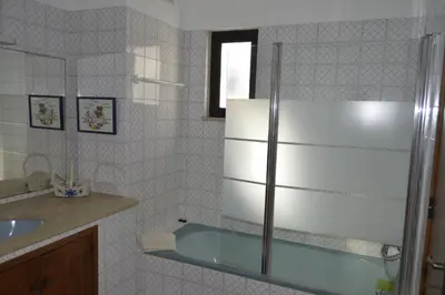 a bathroom with a sink and a refrigerator at Casa de Vilamoura in Vilamoura