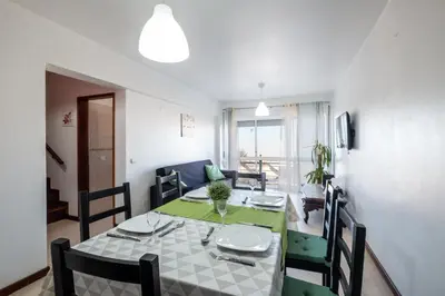a dining room and living room with a table and chairs at #012 Exclusivo para Famílias, Habijovem by Home Holidays in Albufeira