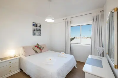 a kitchen with white cabinets and a refrigerator at #012 Exclusivo para Famílias, Habijovem by Home Holidays in Albufeira