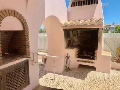 a patio with an outdoor fireplace in a house at Villa Amendoeiras 52 in Albufeira