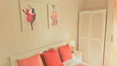 a bedroom with a bed with red pillows at 3 bedroom apartment in Oura Albufeira with amazing pool at walking distance to beach, strip and old town, WIFI and AC, private condo in Albufeira
