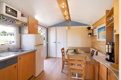 a small kitchen with a table and chairs in it at Cabana Gardenhouse in Loulé