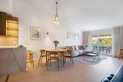 a living room with a table and a couch at Apartment Dansk in Almancil