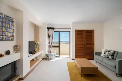 a living room with a couch and a tv at LovelyStay - Bela Vista 3BDR Duplex Penthouse with Pool in Albufeira