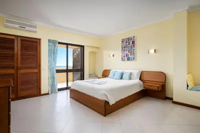 a bedroom with a bed with a view of the ocean at LovelyStay - Bela Vista 3BDR Duplex Penthouse with Pool in Albufeira