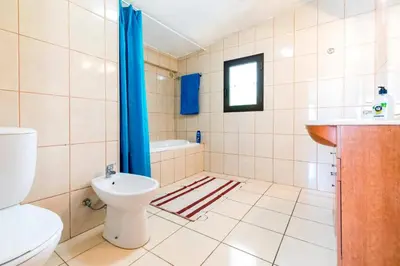 a bathroom with a toilet and a sink at Villa Altis by Villa Plus in Albufeira