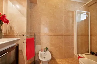 a bathroom with a toilet and a shower and a sink at Villa Elo by Villa Plus in Albufeira