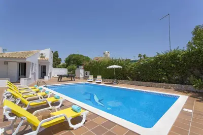 a swimming pool with lounge chairs and a swimming pool at Villa Elo by Villa Plus in Albufeira