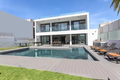 a house with a swimming pool in the backyard at Villa Eve by Villa Plus in Olhos de Água