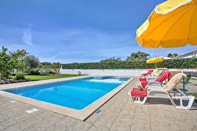 a swimming pool with lounge chairs and an umbrella at Villa Miguel by Villa Plus in Galé