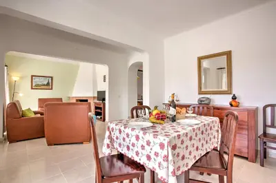 a dining room with a table and a couch at Villa Miguel by Villa Plus in Galé