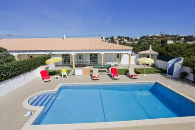 a villa with a swimming pool in front of a house at Villa Miguel by Villa Plus in Galé