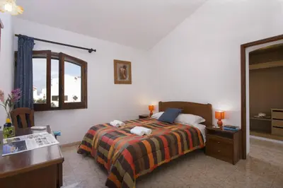 a bedroom with a bed and a desk and a mirror at Villa Montechoro by Villa Plus in Albufeira