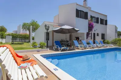 a villa with a swimming pool and a house at Villa Montechoro by Villa Plus in Albufeira