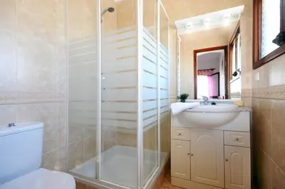 a bathroom with a shower and a sink and a toilet at Villa Montechoro by Villa Plus in Albufeira
