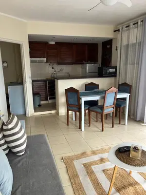 a kitchen and living room with a table and chairs at House Amendoeiras , Vila moura in Vilamoura