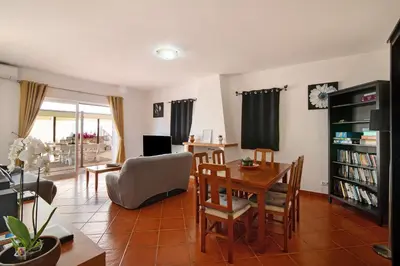 a living room with a table and a dining room at Villa Isabel in Loulé
