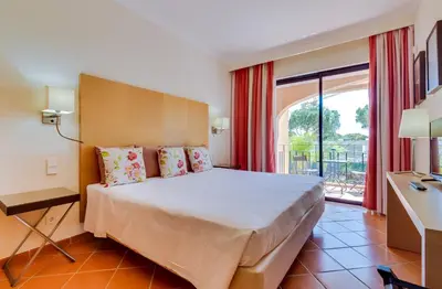 a bedroom with a bed and a large window at AL - Apartamento Vila Sol F5 AA in Vilamoura