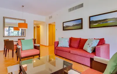 a living room with a couch and chairs and a table at AL - Apartamento Vila Sol F5 AA in Vilamoura