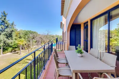 a balcony with a table and chairs and a view at AL - Apartamento Vila Sol F5 AD in Vilamoura