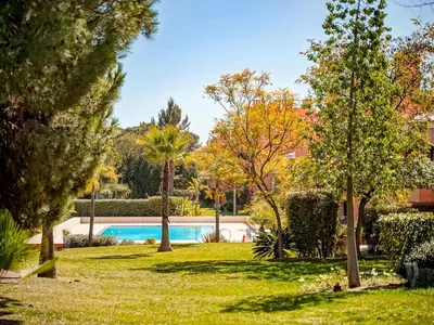 a swimming pool in a park with trees and grass at AL - Apartamento Vila Sol F5 AD in Vilamoura
