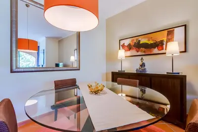 a dining room with a glass table and chairs at AL - Apartamento Vila Sol F5 AD in Vilamoura