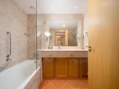 a bathroom with a tub and a sink and a shower at AL - Apartamento Vila Sol F5 AD in Vilamoura