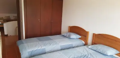 a bedroom with two beds and a closet at New Grand duplex avec terrasse plein sud vue piscine in Vilamoura