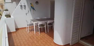 a small kitchen with a table and chairs at New Grand duplex avec terrasse plein sud vue piscine in Vilamoura