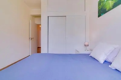a bedroom with a large bed with blue sheets and pillows at Quarteira 2Br - near the beach at Homesbyfc in Quarteira