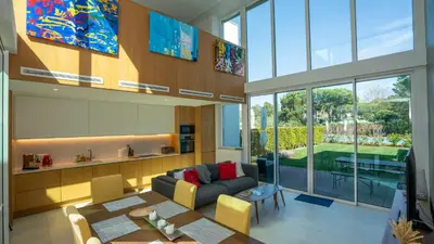 a living room with a couch and a table at Central Vilamoura Townhouse in Quarteira