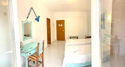 a bathroom with a sink and a table in a room at The Central Guesthouse in Faro