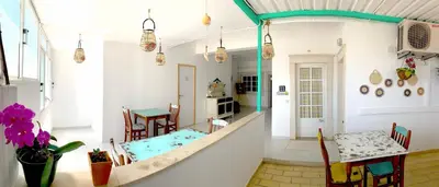 a living room with a pool in the middle of a room at The Central Guesthouse in Faro