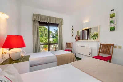 a hotel room with two beds and a window at WHome | Balaia 3-Bed Family Holiday Villa in Olhos de Água