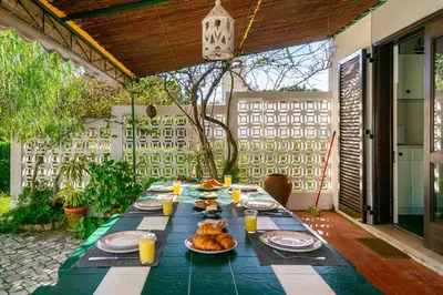 a long table with plates of food on it at WHome | Balaia 3-Bed Family Holiday Villa in Olhos de Água