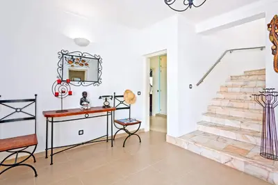a patio with yellow chairs and a swimming pool at Villa Ninho da Aguia by Villa Plus in Albufeira