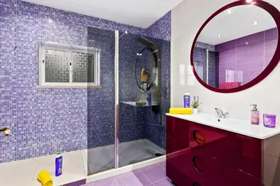 a bathroom with a shower and a sink and a mirror at Villa Ninho da Aguia by Villa Plus in Albufeira