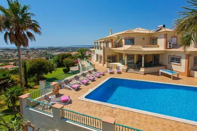 a villa with a swimming pool in front of a house at Villa Nenufa by Villa Plus in Albufeira