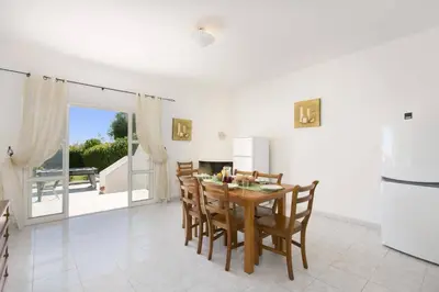 a kitchen with blue cabinets and a sink and a microwave at Villa Animado by Villa Plus in Albufeira
