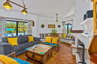 a living room with a couch and a table at Villa Casa do Laguinho by Villa Plus in Albufeira