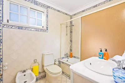 a bathroom with a toilet and a sink and a shower at Villa Aldeia Cristina by Villa Plus in Albufeira