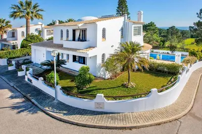 an aerial view of a white house with palm trees at Villa Aldeia Cristina by Villa Plus in Albufeira