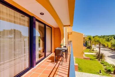 a balcony with a table and chairs on a house at AL - Apartamento Vila Sol F5 AB in Vilamoura