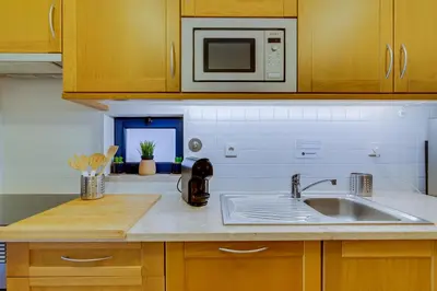 a kitchen with a sink and a microwave at AL - Apartamento Vila Sol F5 AB in Vilamoura