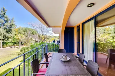 a table and chairs on the balcony of a house at AL - Apartamento Vila Sol F5 AB in Vilamoura
